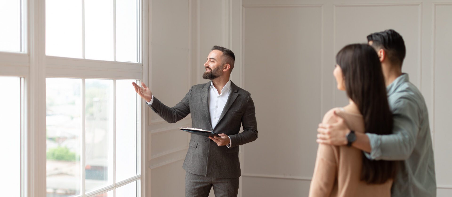 Real Estate Agent Showing Young Buyers New Property