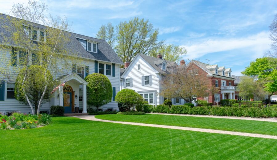 Traditional suburban homes with green front lawns